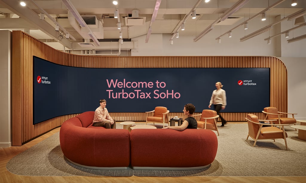 a group of people sitting around a couch in a room