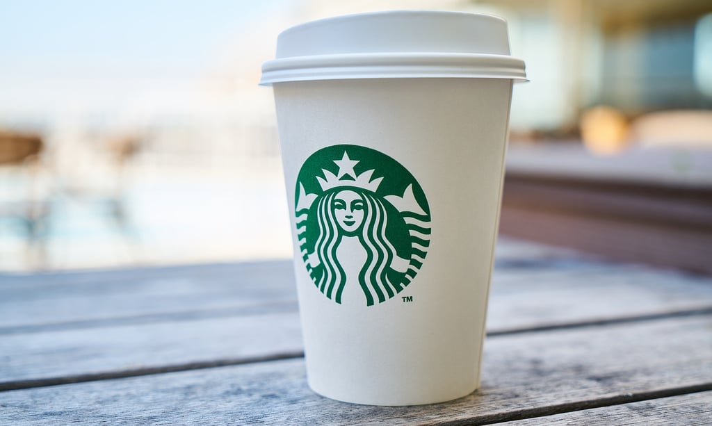 a starbucks cup on a wood table