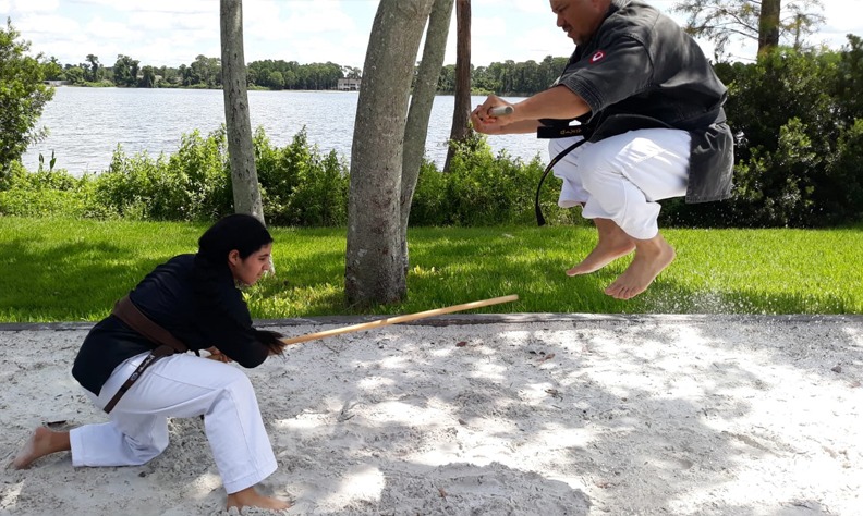 Kobudo practice with traditional Okinawan weapons in martial arts dojo