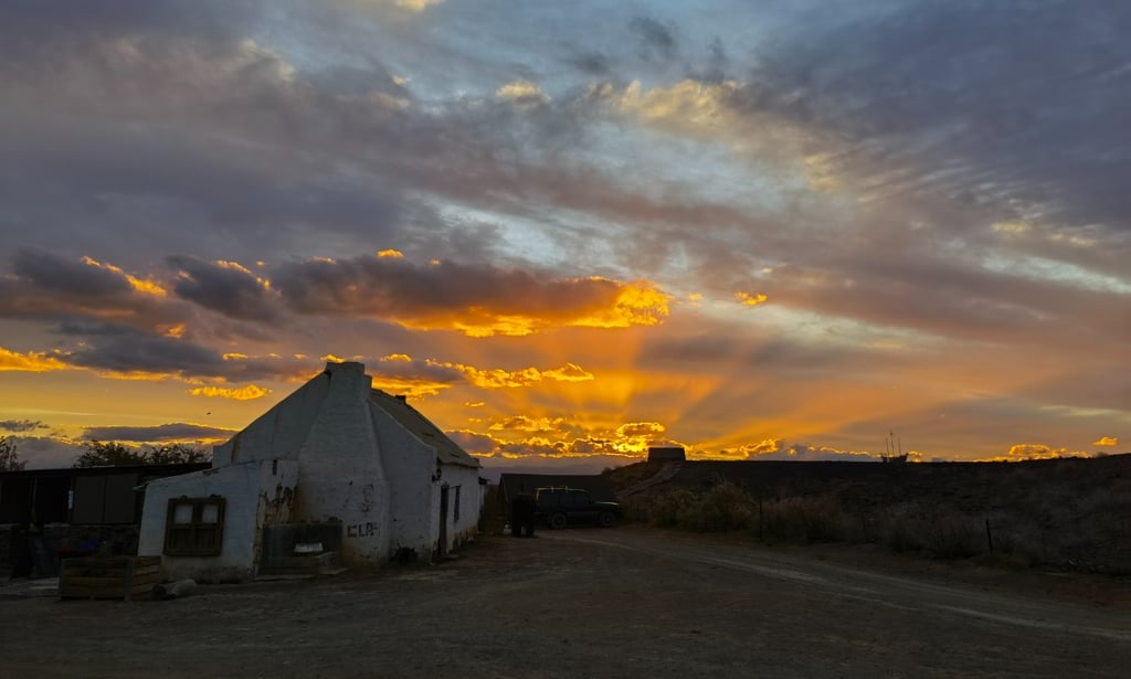a house with a sunset in the background
