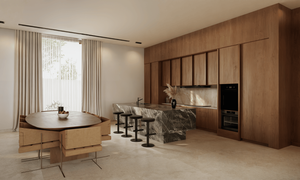 A kitchen with wooden cabinetry, a marble-topped island with black stools, and a wooden dining table