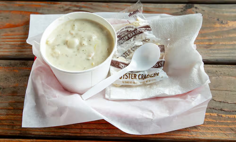 Clam chowder cup with potatoes and herbs served with oyster crackers from Captain’s Galley.