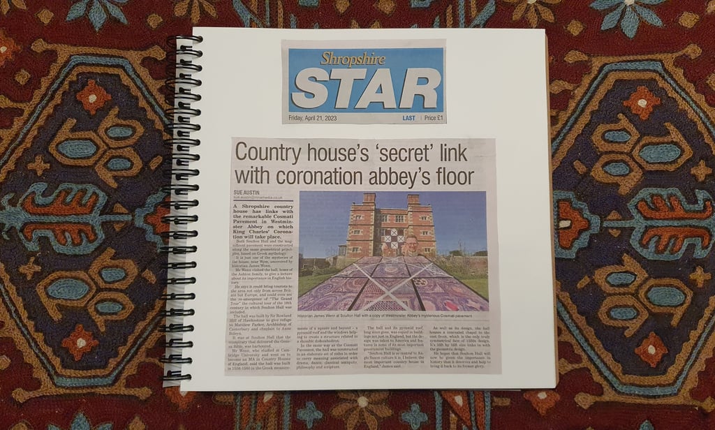 Ring-bound square book showing a newspaper clipping from the Shropshire Star