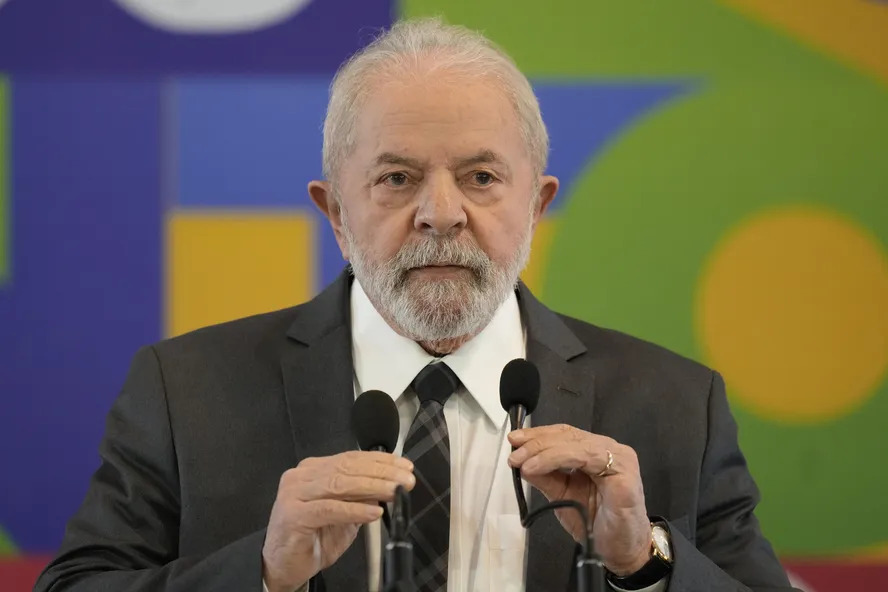 a man in a suit and tie is speaking into a microphone