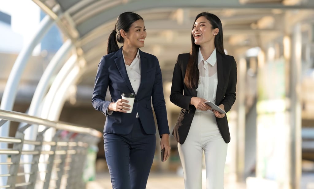 2 women walking in a building