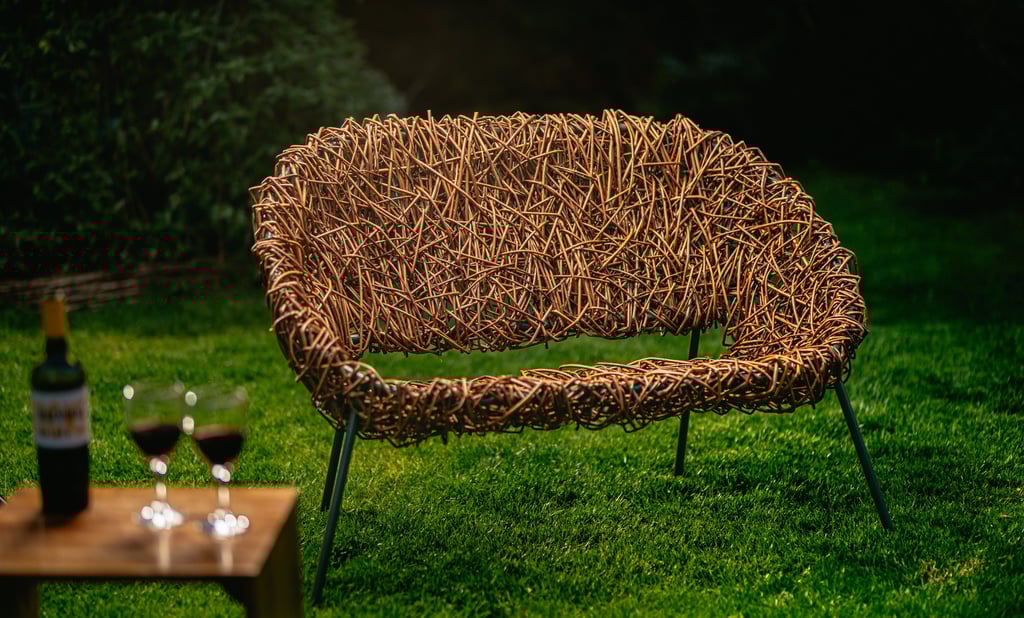 Bespoke 2-seater willow chair with modern green metal frame, handwoven design