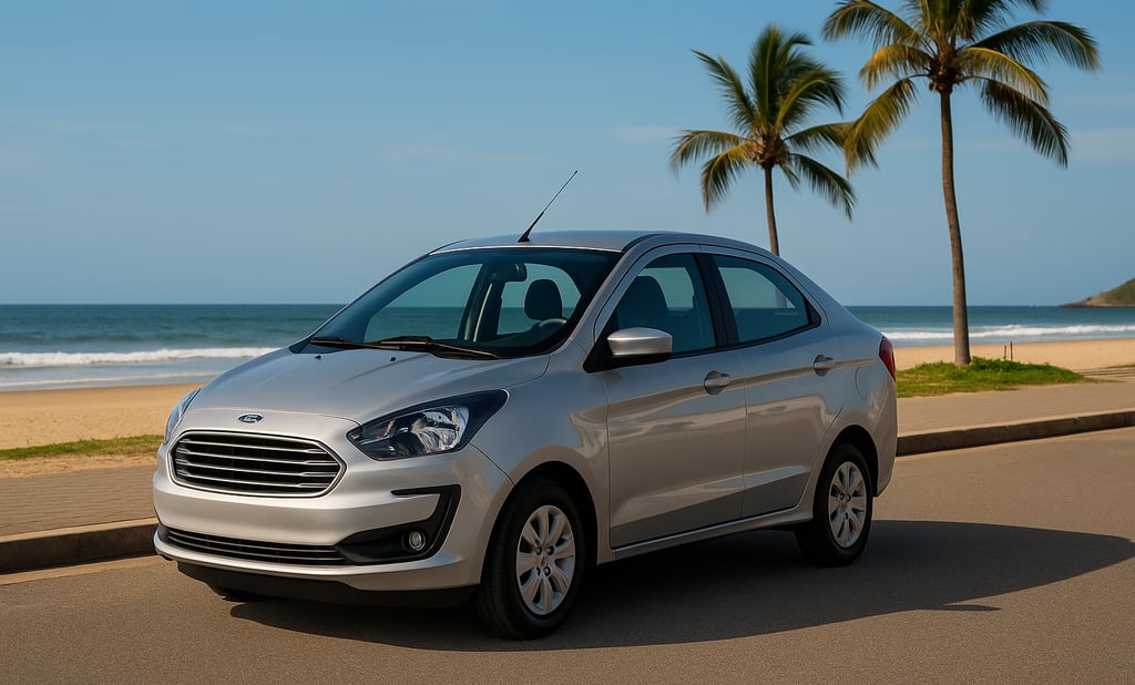 Ford Ka Sedan prateado estacionado próximo à praia com mar e coqueiros ao fundo em dia ensolarado.