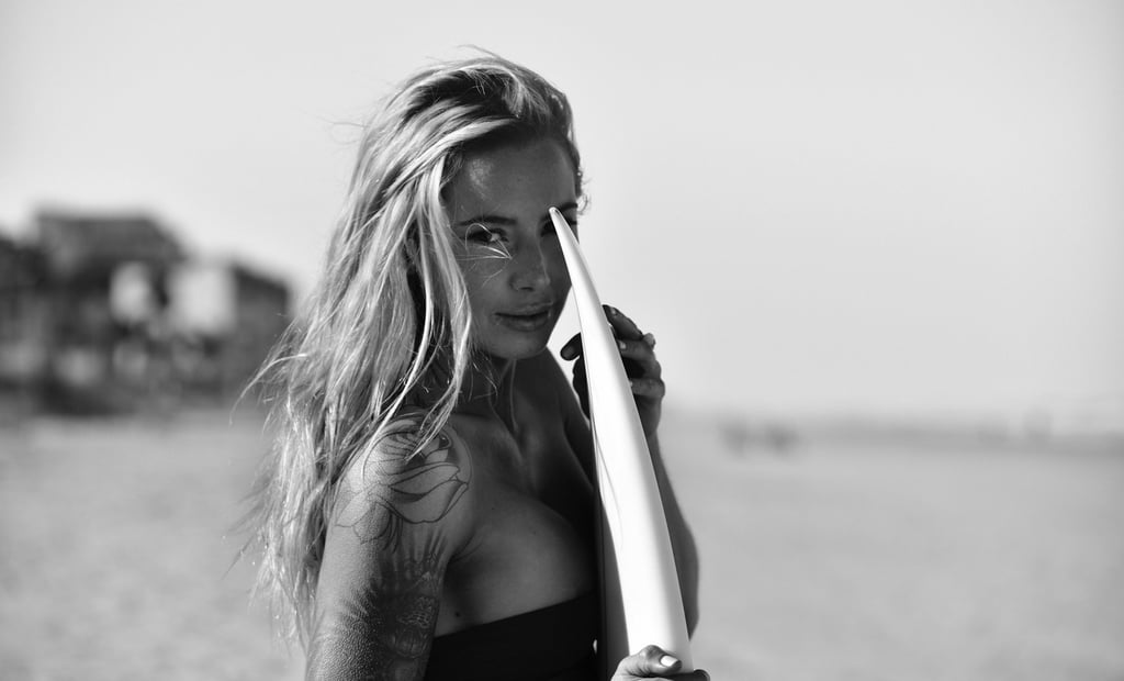 A portrait of a blonde surfer girl
