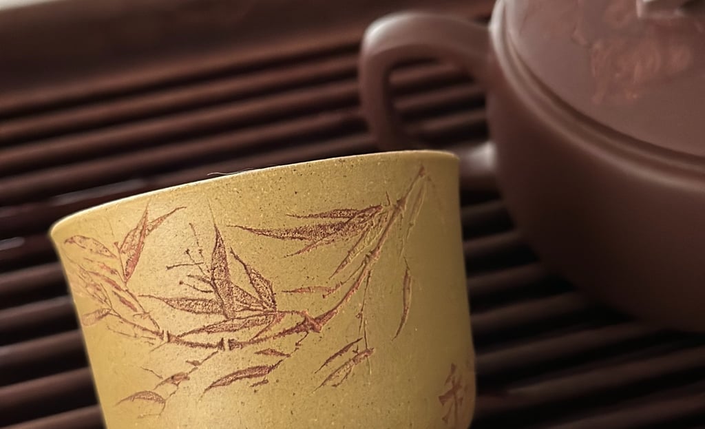 Yellow teacup engraved with artwork