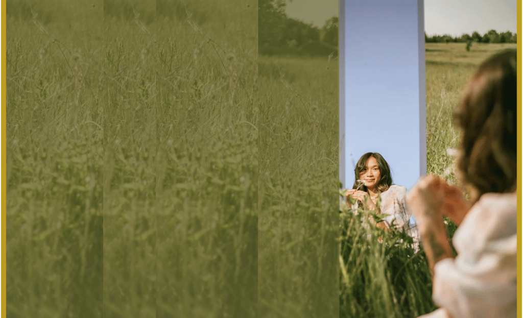 Woman gazing into mirror in meadow, symbolizing inner alignment, reflection, and self-leadership