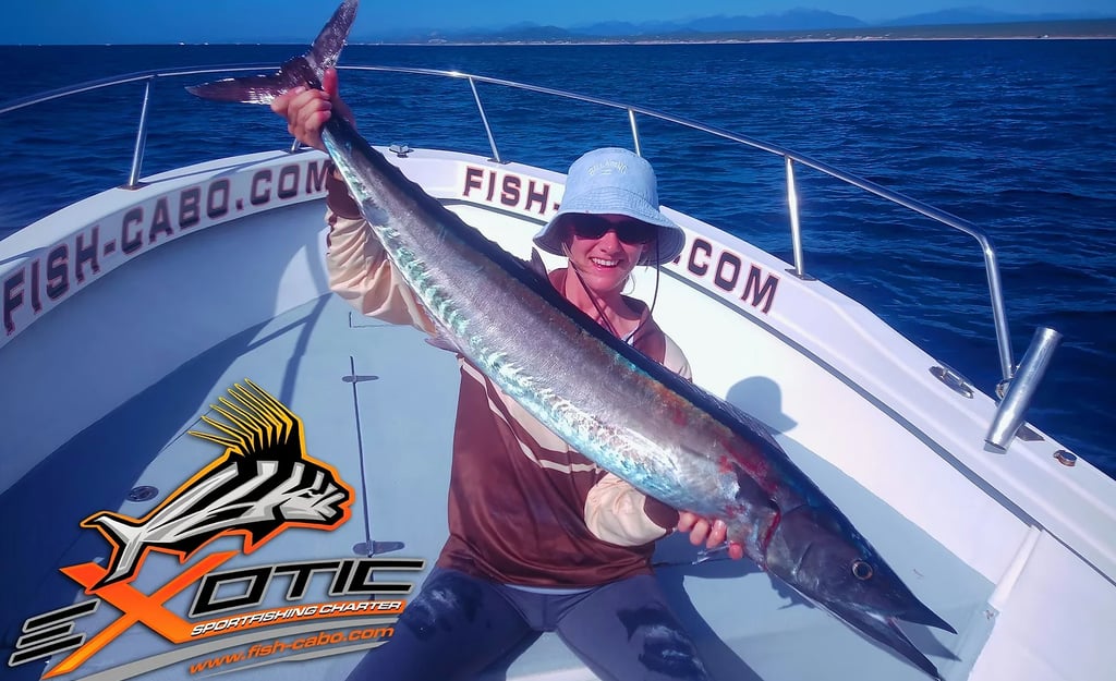 a man holding a fish fish on a boat