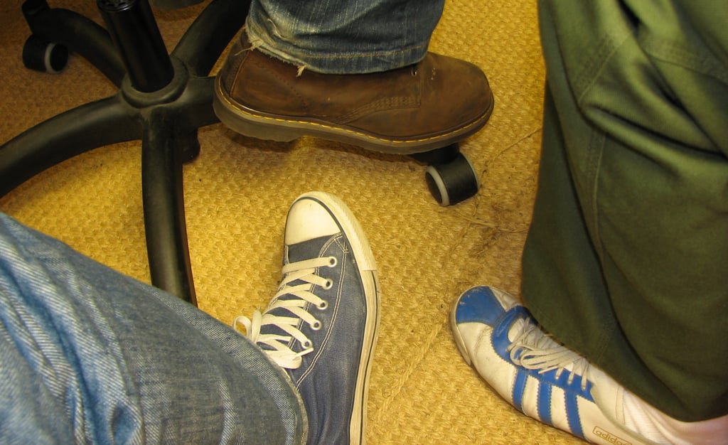 Trois pieds chaussés de trois chausures de style différent