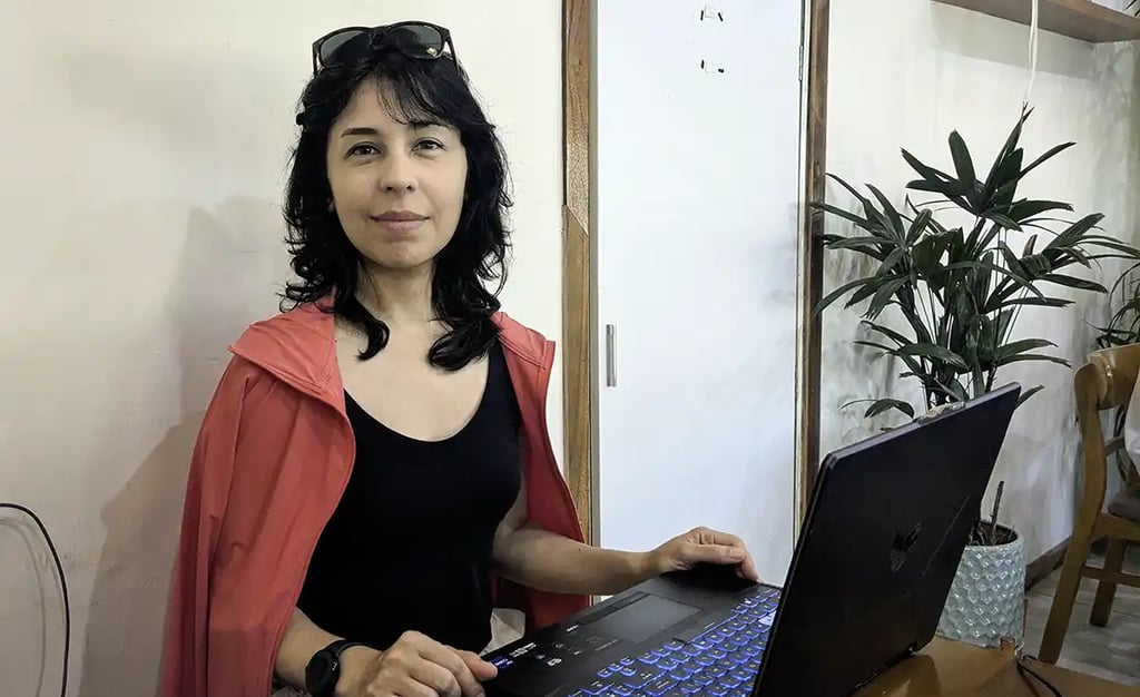 A woman working on a laptop while reflecting on her seven-week stay in Vietnam