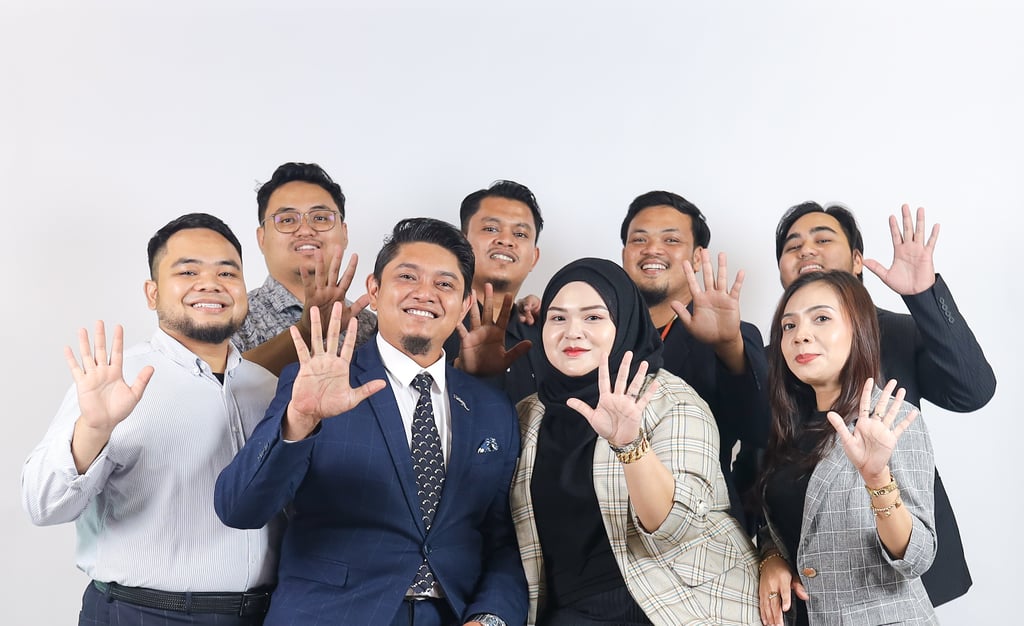 a group of people standing around a man in a suit