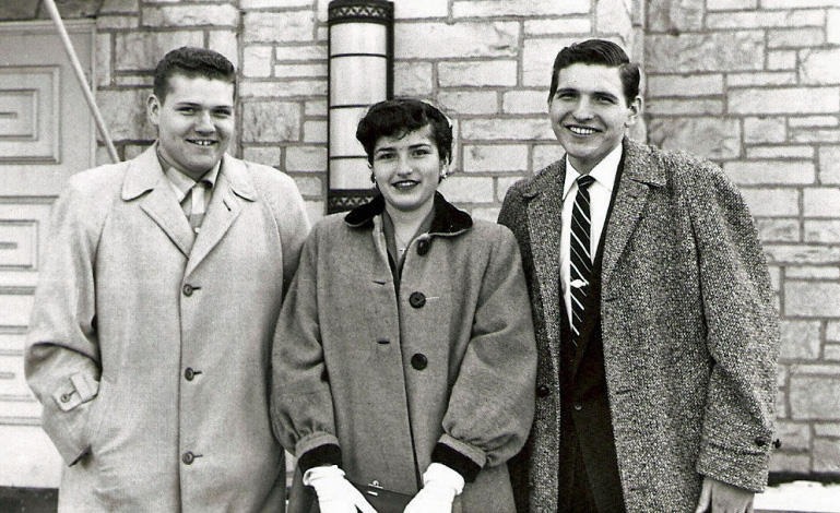 two men and a woman standing next to each other
