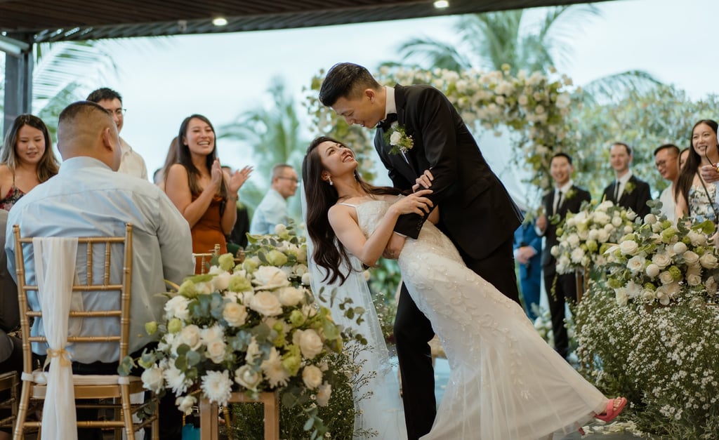 a bride and groom kissing in a wedding ceremony