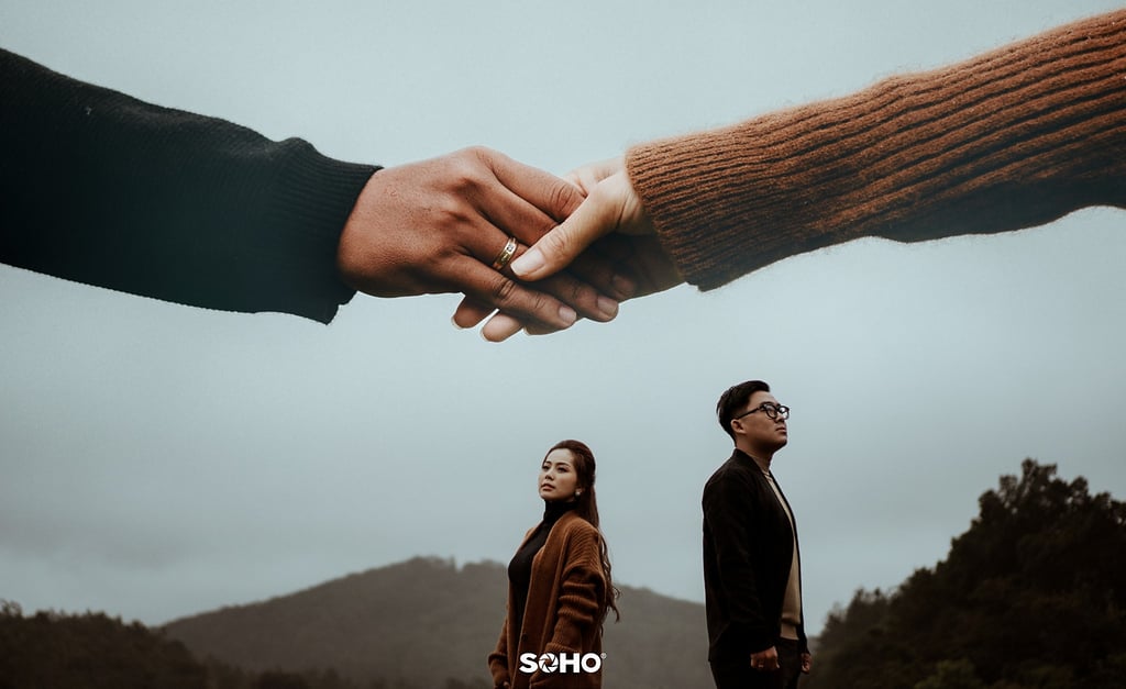 a man and woman holding hands in front of a mountain