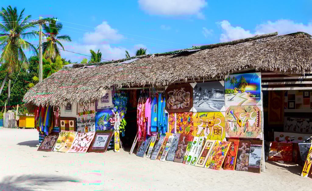 Colorful Dominican paintings displayed at a beach art and souvenir shop in the Dominican Republic