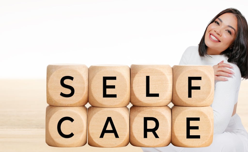 a woman sitting with a wooden block with the words self care