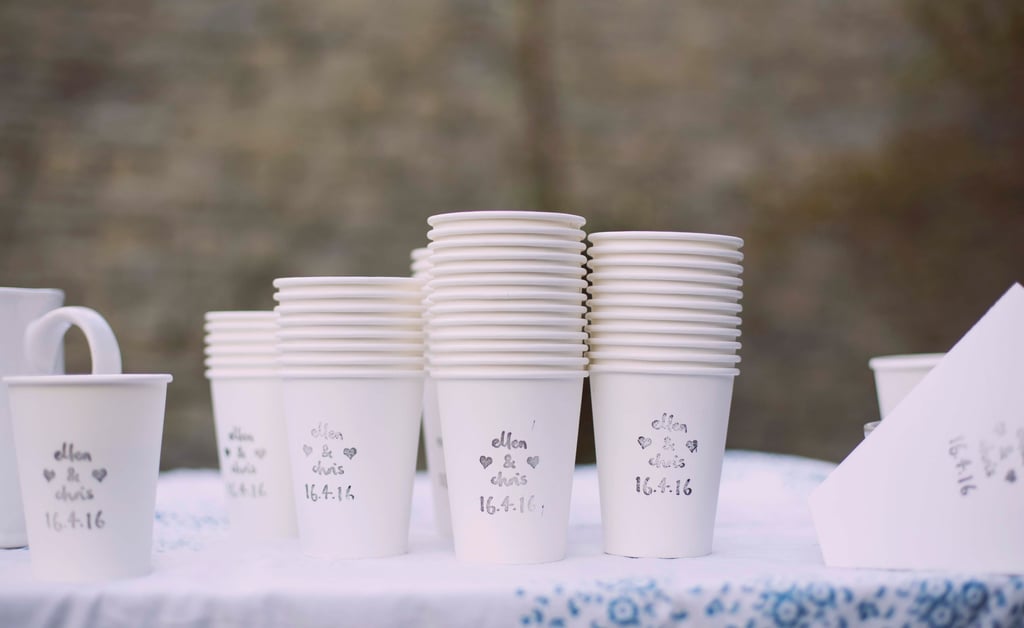 Photo of paper cups with wedding date and bride and groom's names stamped on