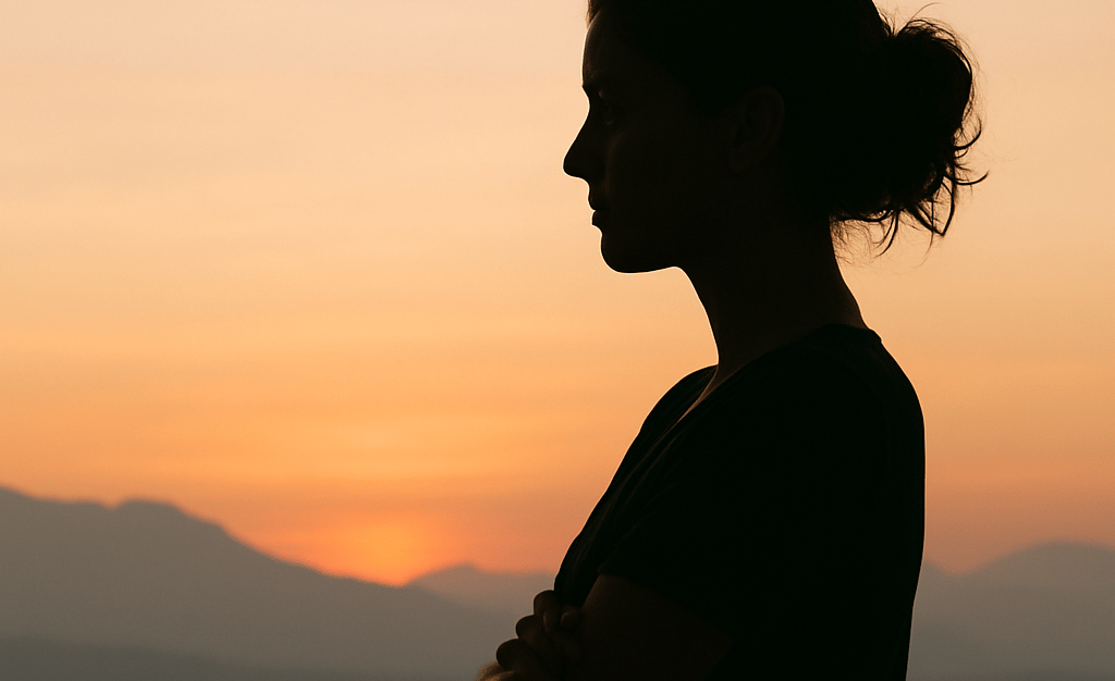 A subtle silhouette of a woman with arms folded gently or standing in quiet reflection.