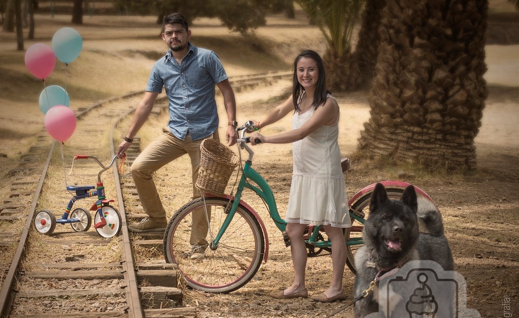 a man and woman standing next to a train track