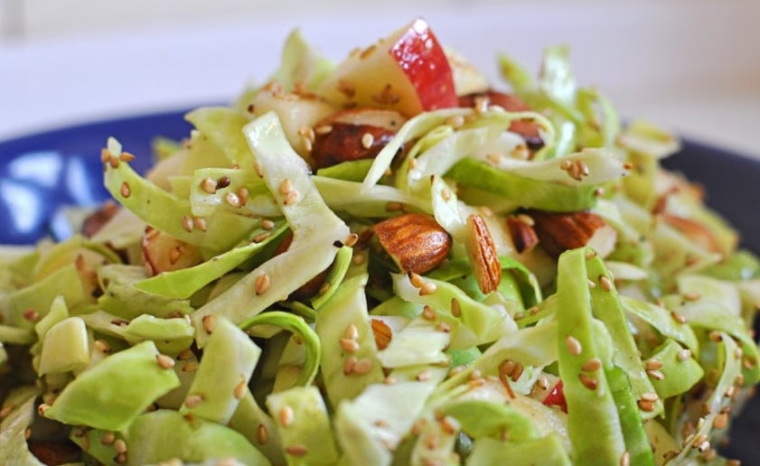 Cabbage juicy salad with apples, sesam and almonds