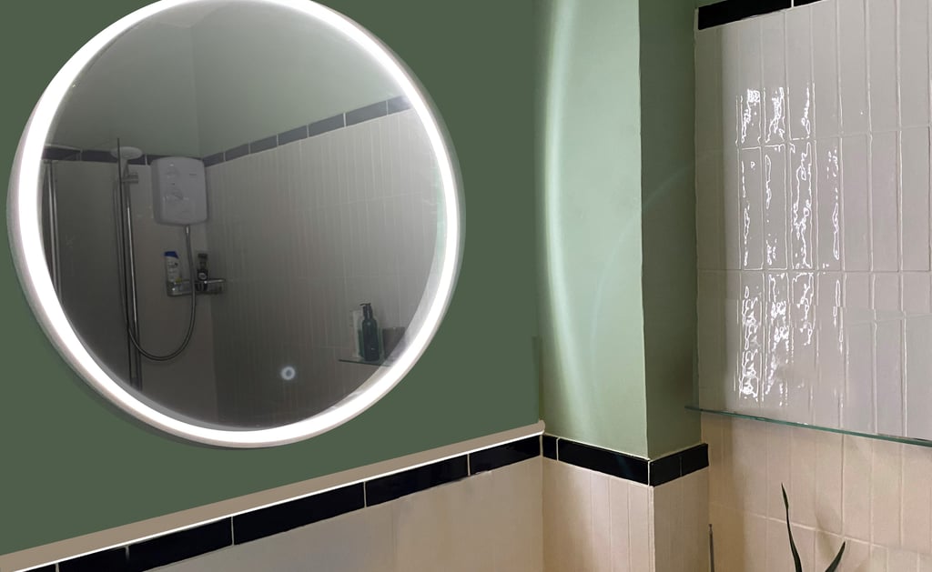 Image of bathroom after redesign, long gloss tiles and green paint make the bathroom calm