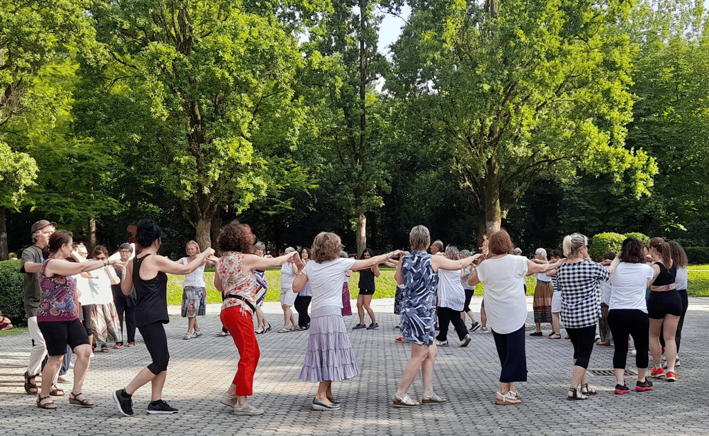 a group of people standing around a circle with their arms outstretched out