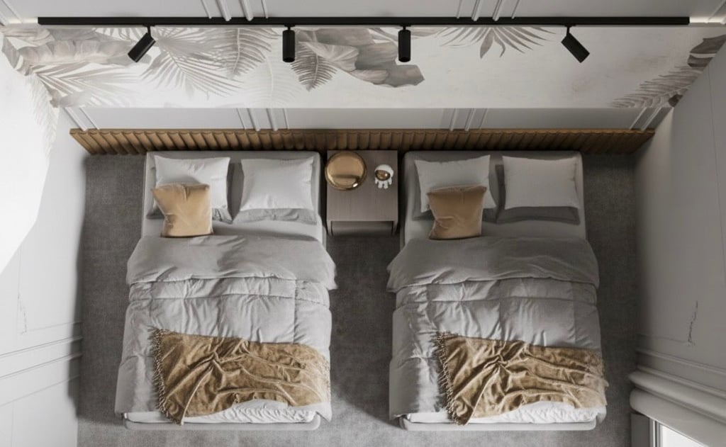 two beds in a bedroom with a wooden headboard Nour Nagy Designs