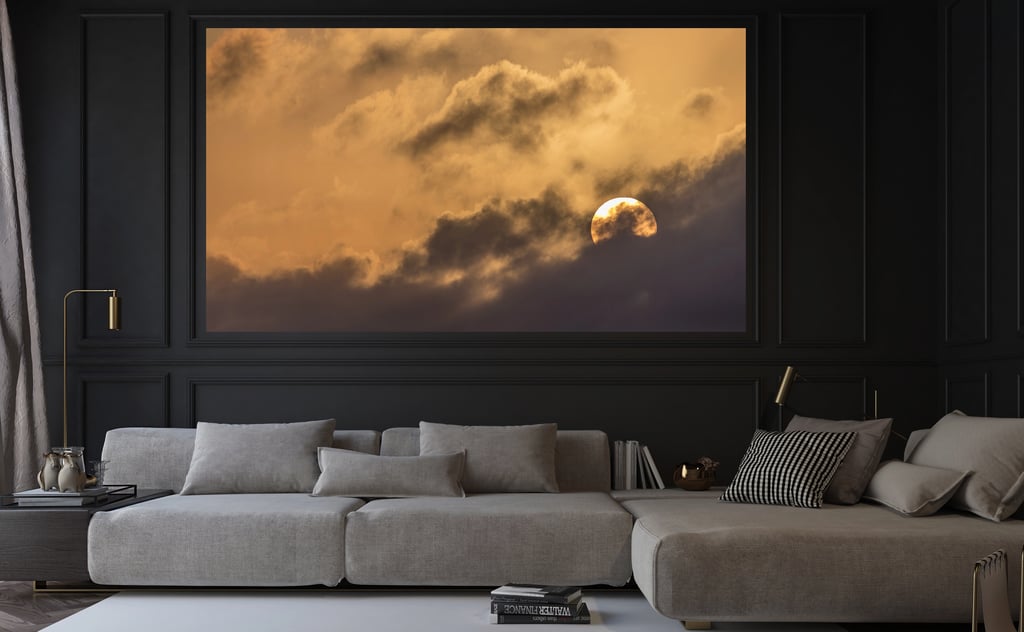 a couch with a large picture of the moon setting