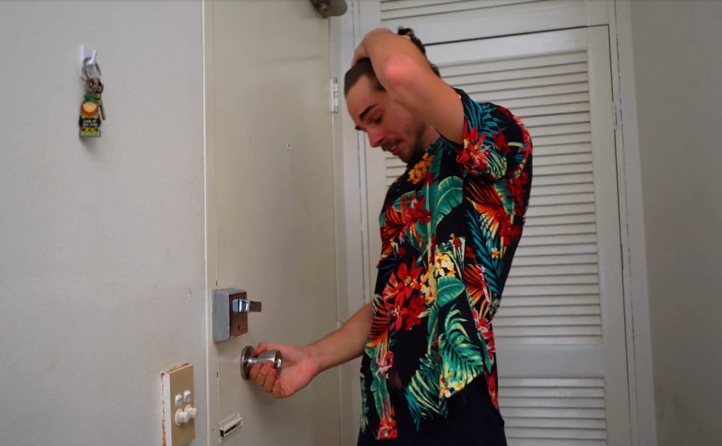 a man in a hawaiian shirt is holding a keychain