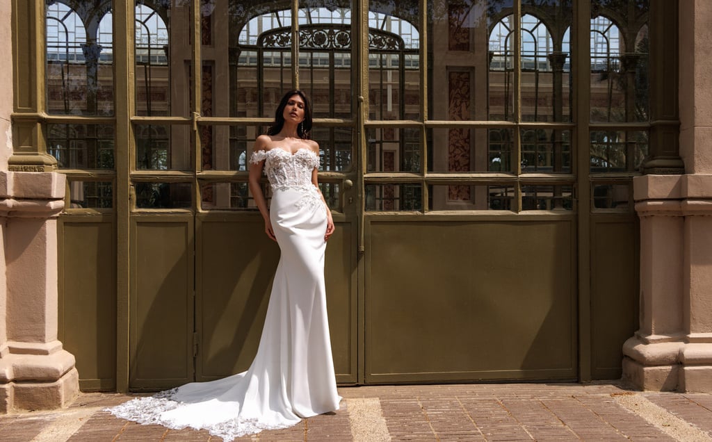 a woman in a white dress standing in front of a large building