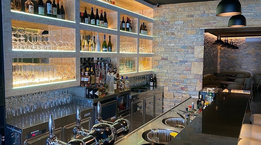a bar with a bar with a bar stool and a bar with a bar stool