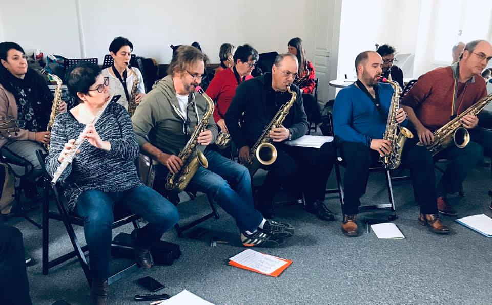 a group of people sitting in chairs playing instruments