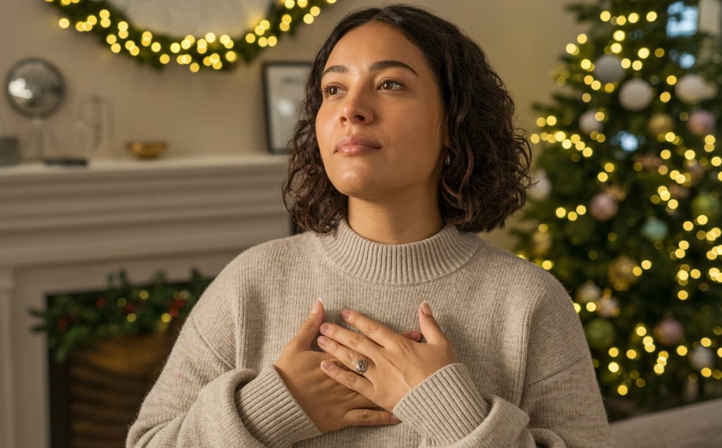 a woman in a sweater holding her hands up to her chest