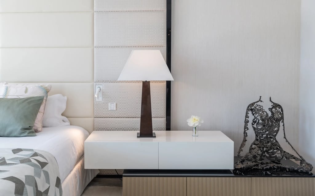 Modern bedside table with lamp and sculpture at Villa Serenity