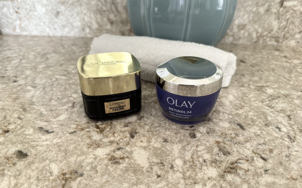 Olay night cream and RoC moisturizer with white washcloth on counter, calm skincare scene
