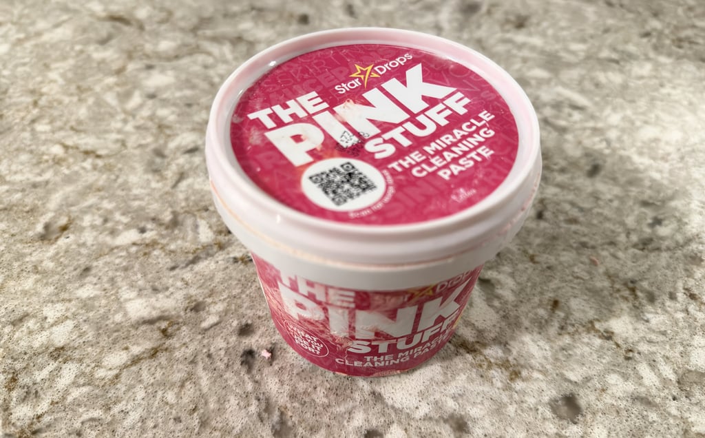 The Pink Stuff cleaning paste container on a bathroom counter for toilet cleaning