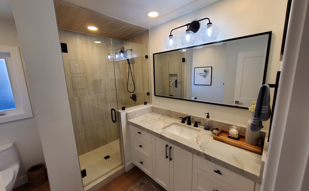 Compete bathroom renovation with recessed lights, sleek shower and counter top. personalized bathrooms Colorado Springs.
