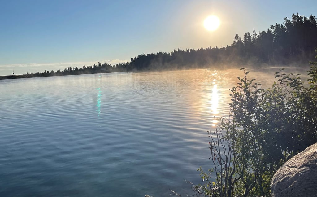 a lake with rocks and water in the background