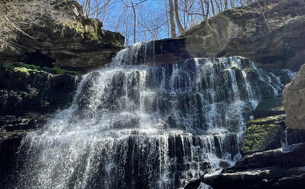 a waterfall in the middle of a rocky cliff
