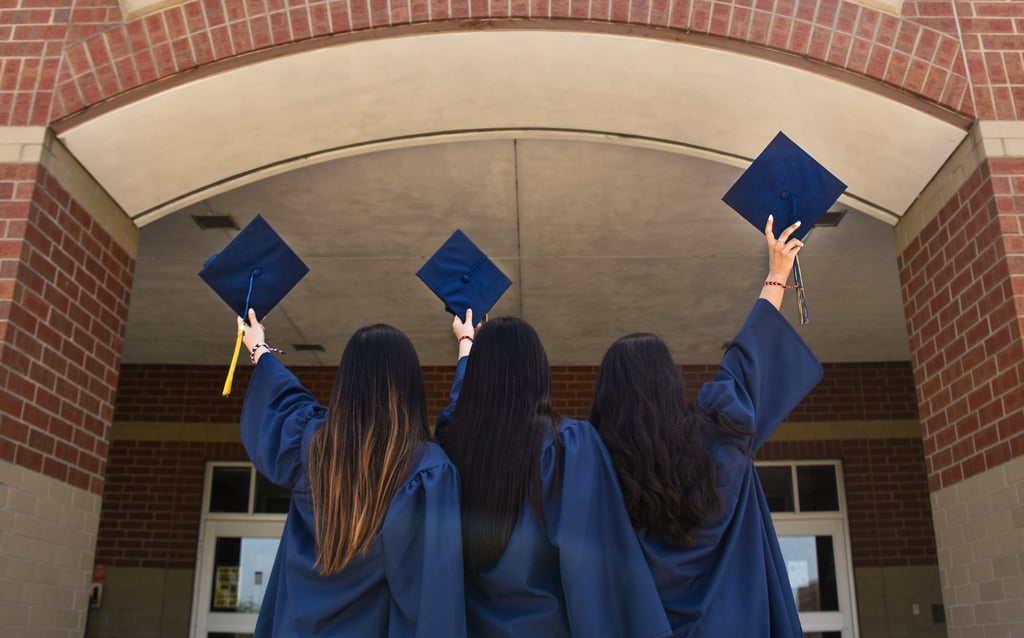 Three graduates in blue caps celebrating academic success under the label 'ACADEMICS'