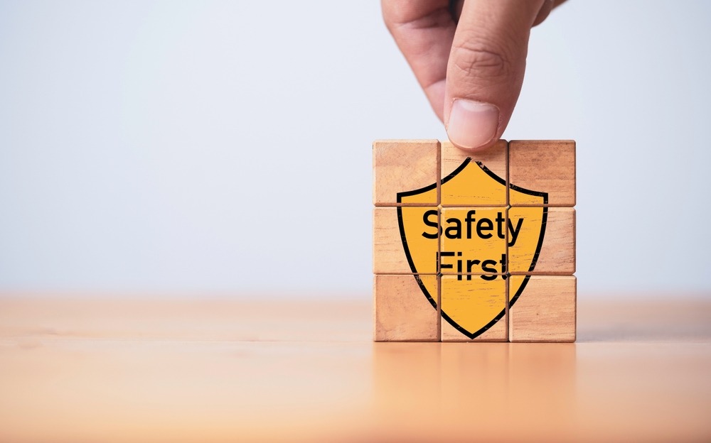 Building blocks with the graphic of a yellow shield saying "Safety First" on the front