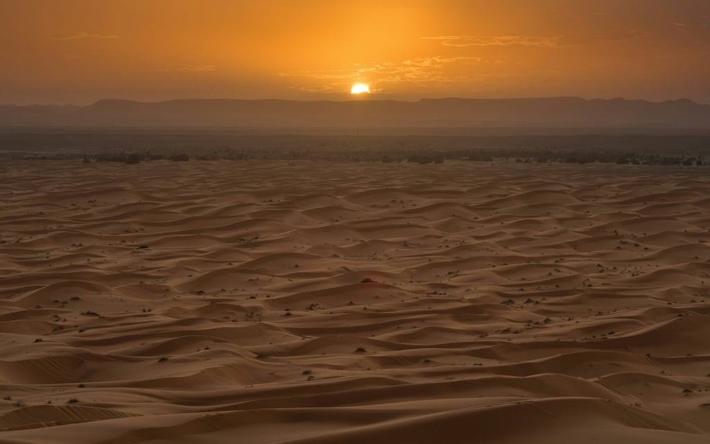 Sahara desert sunset in Morocco with golden dunes during a camel trekking experience
