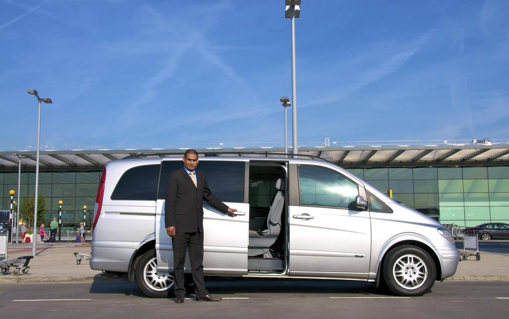 morocco a man in a suit and tie standing in front of a van