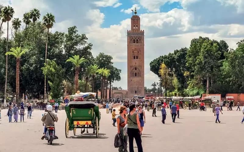 morocco marrakech a group of people walking around a plaza