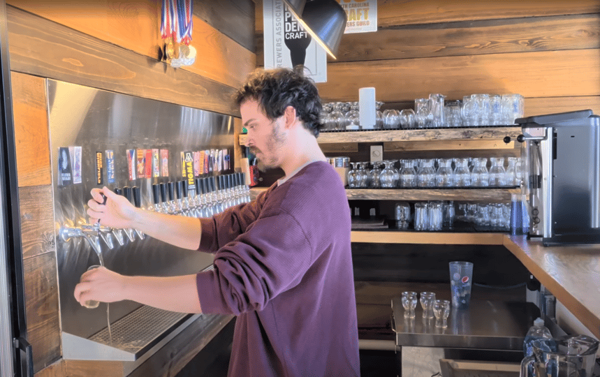 Hunter of Lost Province Brewing tapping a pint of beer