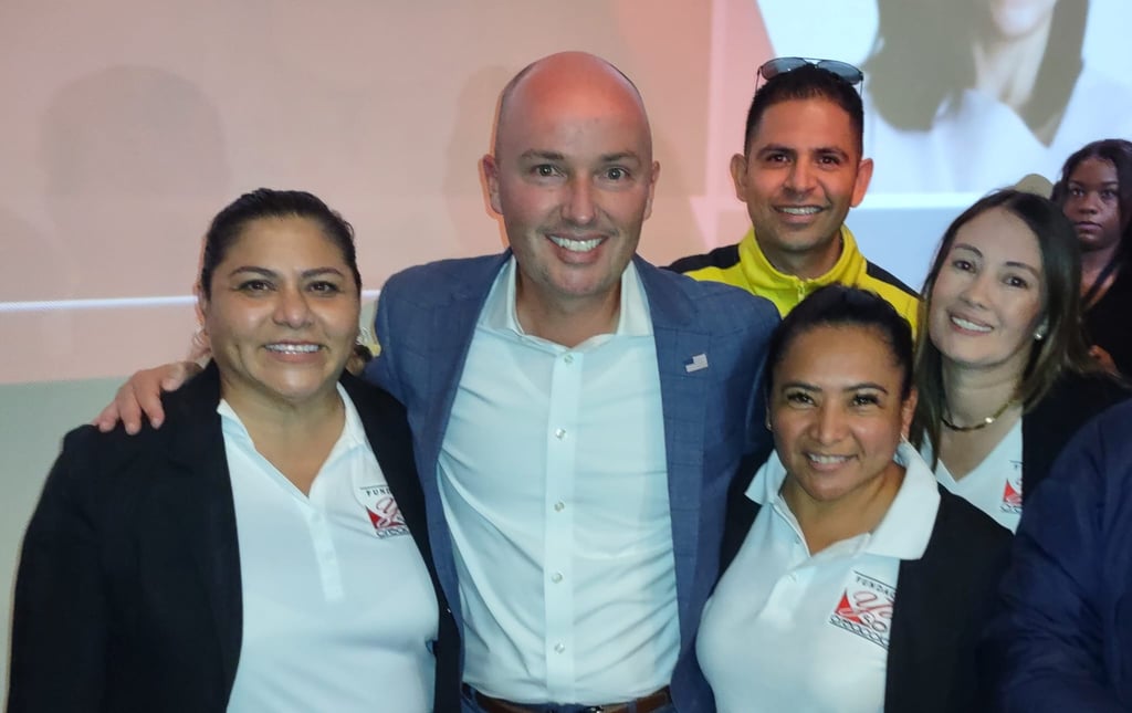 A group of professionals smiling together at a business networking event conference.