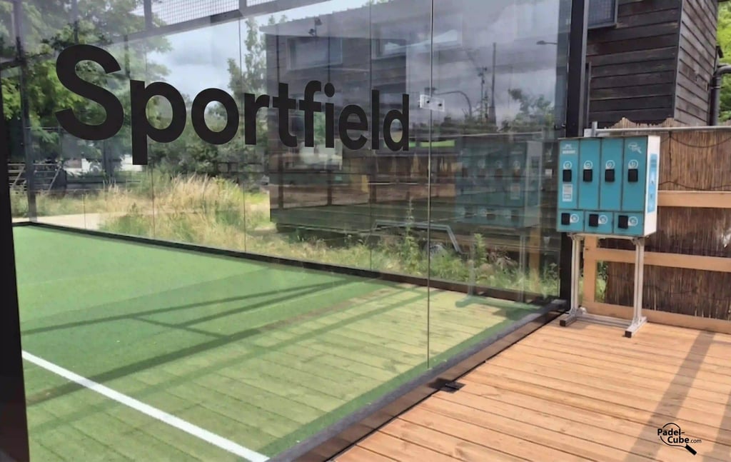 Outdoor Sportfield padel court with glass walls and equipment lockers on a wooden deck.